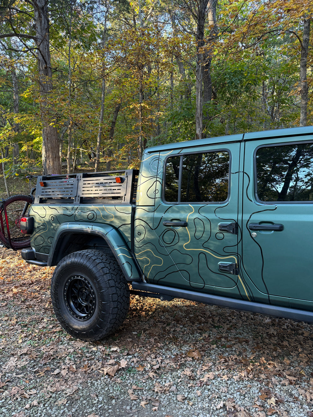 Rear three-quarter view of black and gold topo lines