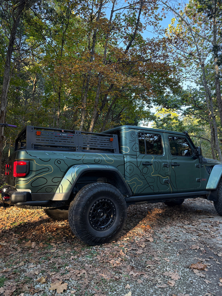 Low rear three-quarter view of the DIY Topo Kit install under fall trees